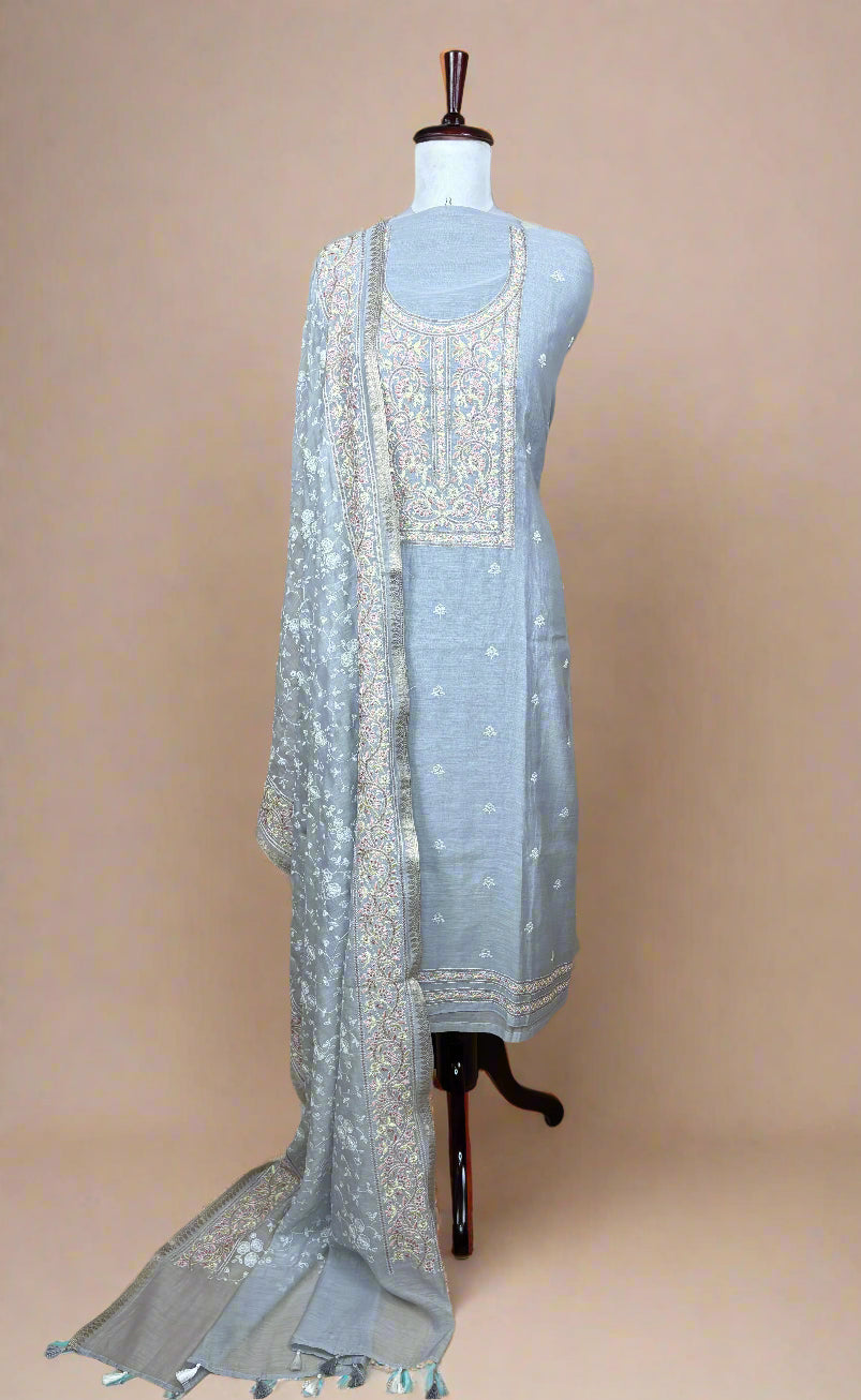 Light blue embroidered dress with matching dupatta on a mannequin against a beige background